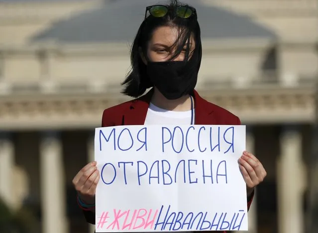 A woman holds a sign reading “My Russia Is Poisoned. Navalny, Stay Alive” as she stages a one-person protest in support of Russian opposition activist Alexei Navalny in Novosibirsk, Russia on August 21, 2020. On 20 August, Navalny felt bad during his flight from Tomsk to Moscow and was hospitalised into Omsk Ambulance Hospital No 1 in a suspected poisoning after his flight's emergency landing. (Photo by Kirill Kukhmar/TASS)