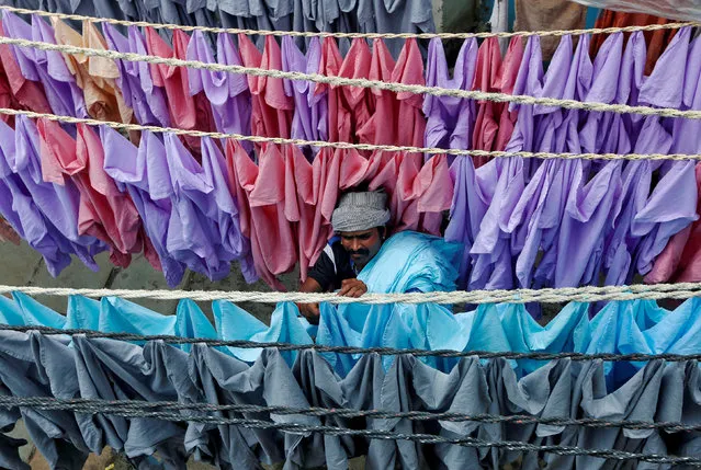 A man hangs shirts out to dry in an open-air laundry in Mumbai, India August 30, 2016. (Photo by Shailesh Andrade/Reuters)