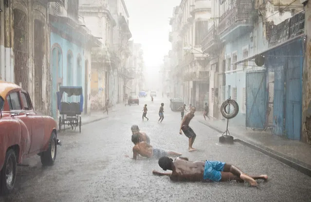 “Havana, Cuba. Havana weather in July and August counts as brutally hot. Short but heavy rains are very common and welcomed by locals, especially kids”. (Photo and comment by Val Proudkii, USA/2013 Sony World Photography Awards
