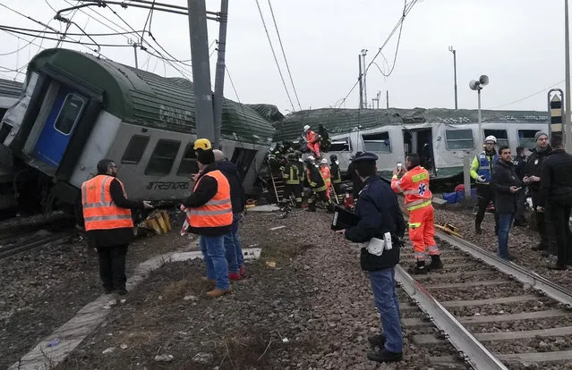Rescuers work at the wrecked car of a train that derailed at the station of Pioltello Limito, on the outskirts of Milan, Italy, Thursday, January 25, 2018. (Photo by AP Photo/Stringer)