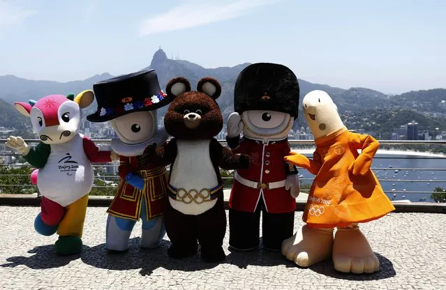 Mascots from other editions of the Summer Olympic Games (L-R) Fu Niu Lele  (Beijing 2008), Wenlock (London 2012), Misha (Moscow 1980), Mandeville (London 2012) and Athena (Athens 2004) pose for a picture on top of Sugar Loaf mountain in Rio de Janeiro November 21, 2014. This is the first time that mascots from previous Olympic games are visiting the current Olympic host city, ahead of the first public appearance of the 2016 mascots on November 24. (Photo by Sergio Moraes/Reuters)