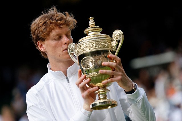 taly's Jannik Sinner celebrates with the trophy after winning the men's final against Spain's Carlos Alcaraz at Wimbleson on July 13, 2025. (Photo by Stephanie Lecocq/Reuters)