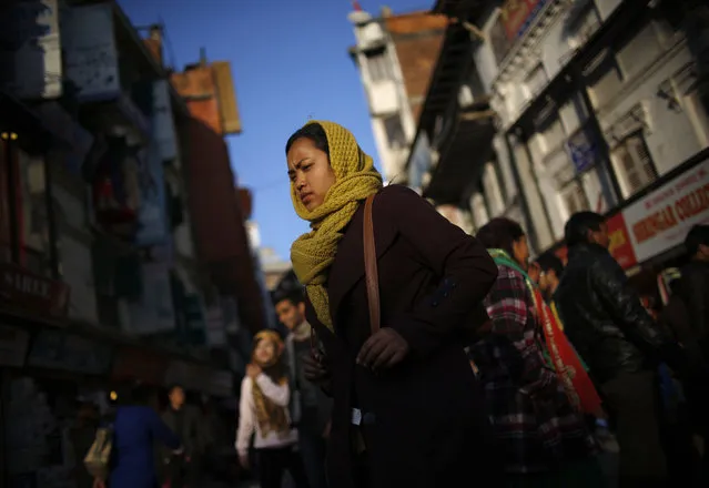 People walk along the busy marketplace in Kathmandu, Nepal January 18, 2016. (Photo by Navesh Chitrakar/Reuters)