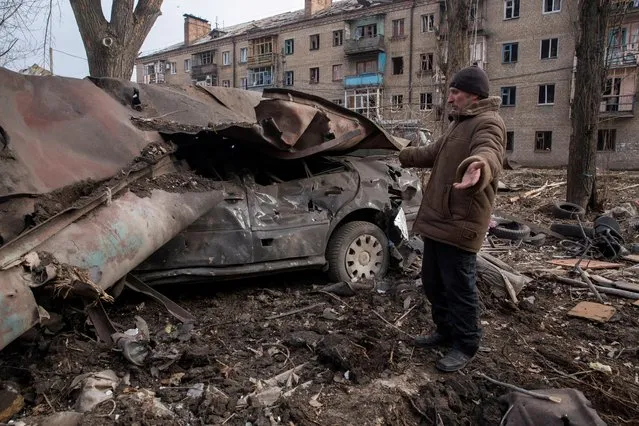 Serhii, a local resident stands next to his car destroyed by a Russian missile strike, amid Russia's attack on Ukraine, in Kostiantynivka, Donetsk region, Ukraine on January 28, 2023. (Photo by Oleksandr Ratushniak/Reuters)