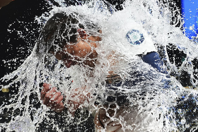 Seattle Mariners' Cole Young is doused by teammate J.P. Crawford after hitting a game-winning single against the Houston Astros during the 11th inning of a baseball game Saturday, July 19, 2025, in Seattle. (Photo by Lindsey Wasson/AP Photo)