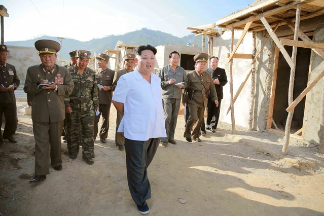 North Korean leader Kim Jong Un gives guidance on the field during the drive for recovery from the flood that hit Rason city in this undated picture. (Photo by Reuters/KCNA)