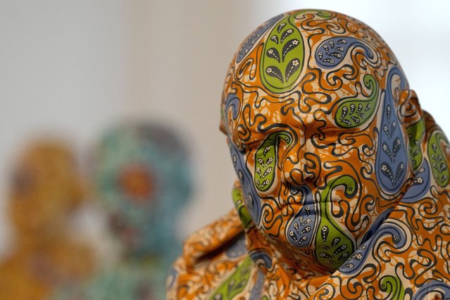 A fiberglass and hand-painted sculpture of Winston Churchill by artist Yinka Shonibare is on display during a photo call for his Suspended States exhibition, at Serpentine South in London, April 11, 2024. (Photo by Frank Augstein/AP Photo)