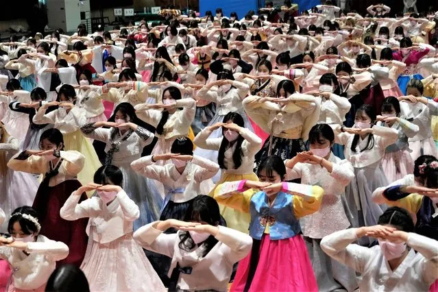High school seniors clad in traditional attire bow during a joint graduation and coming-of-age ceremony at Dongmyung Girls' High School in Seoul, South Korea, Tuesday, February 7, 2023. (Photo by Ahn Young-joon/AP Photo)