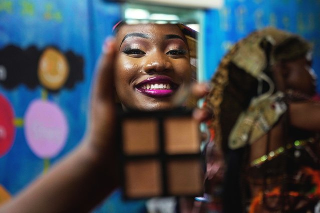A model is reflected in the mirror applying makeup during the Mr. and Mrs. Kibera leadership contest, on International Youth Day, in Nairobi, Kenya, Tuesday, August 12, 2025. (Photo by Brian Inganga/AP Photo)