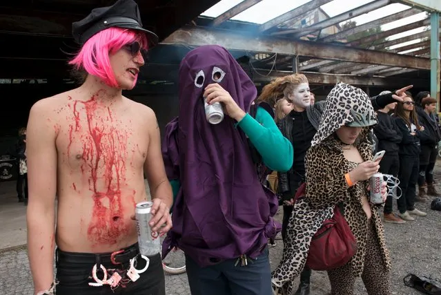 Participants in costume drink beer on the sidelines during "Bike Kill 12" in the Brooklyn borough of New York City, October 31, 2015. "Bike Kill" is an annual gathering of builders and riders of home-made bicycles that culminates in a tall bike jousting competition. (Photo by Stephanie Keith/Reuters)