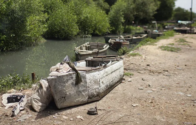 A makeshift fishing boat, made of styrofoam or polystyrene, sits on the bank of a canal leading to the sea in Granma Province, the region from where many would-be emigrants launch makeshift boats to try and reach Honduras with the goal of continuing from there overland to the United States, in Manzanillo September 13, 2014. (Photo by Alexandre Meneghini/Reuters)