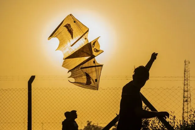 People take part in the annual kite festival at Abu Nawas park in Baghdad, on March 17, 2023. (Photo by Murtadha Ridha/AFP Photo)