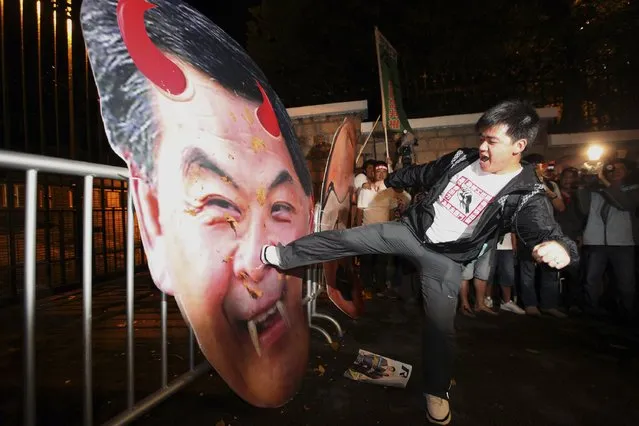 A protester in support of dock workers kicks a defaced portrait of Hong Kong Chief Executive Leung Chun-ying, outside his residency, in Hong Kong April 26, 2013. The protesters say the government should play a role to settle the issue. More than 200 dock workers have been on strike for four weeks for a pay rise at a port operated by tycoon Li Ka-shing, which has disrupted traffic in the world's third-largest container port. (Photo by Reuters/Stringer)