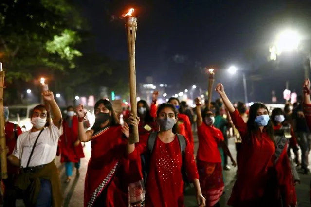 Female students and activists join in a torch procession as they protest against the violence towards women in Dhaka, Bangladesh, November 25, 2020. (Photo by Mohammad Ponir Hossain/Reuters)