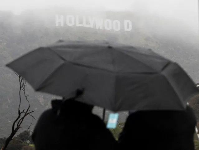 Visitors come to look at the Hollywood sign during a rare cold winter storm in the Los Angeles area, in Los Angeles, California, U.S., February 24, 2023. (Photo by Aude Guerrucci/Reuters)