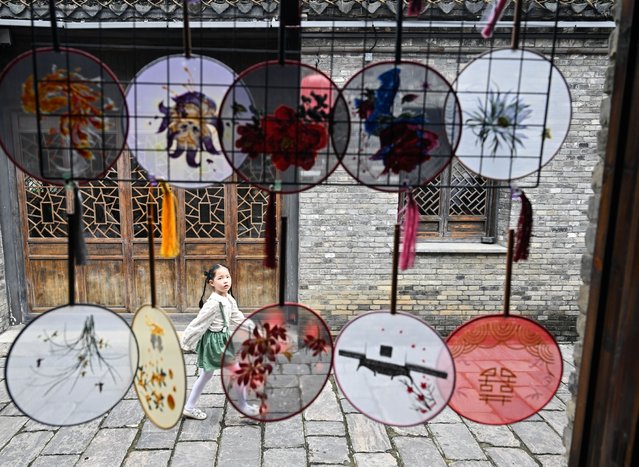 A girl walks on a historical and cultural block of Xuyi County, east China's Jiangsu Province, on October 1, 2025. Xuyi County of Jiangsu Province has introduced a series of measures to boost tourism during the National Day holiday, such as free admission to a local scenic spot, and distribution of consumption vouchers, in an effort to unleash the vitality of tourism-driven economy during the holiday. (Photo by Xinhua News Agency/Rex Features/Shutterstock)