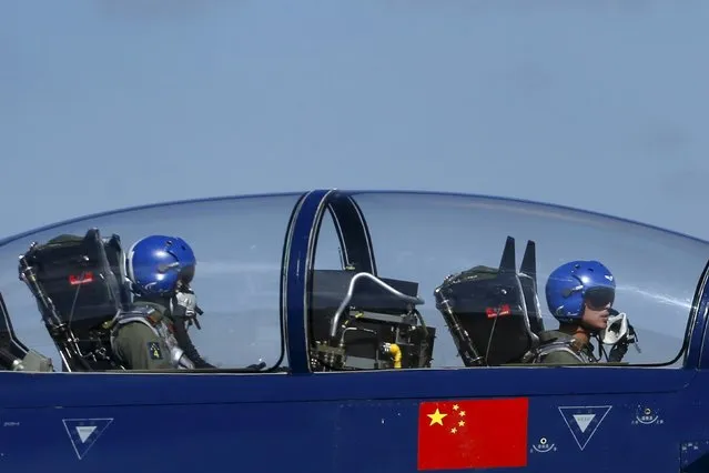 Pilots of China's J-10 fighter jet from the People's Liberation Army Air Force August 1st Aerobatics Team prepare before a media demonstration at the Korat Royal Thai Air Force Base, Nakhon Ratchasima province, Thailand, November 24, 2015. (Photo by Athit Perawongmetha/Reuters)