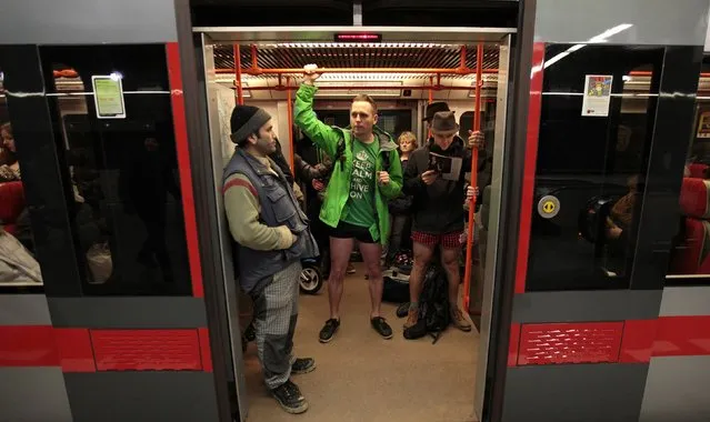 Passengers not wearing pants stand in a subway train during the “No Pants Subway Ride” in Prague January 11, 2015. (Photo by David W. Cerny/Reuters)