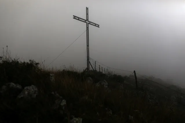A cross stands on a hilltop near the town of Rocca Calascio in the province of L'Aquila in Abruzzo, inside the national park of the Gran Sasso e Monti della Laga, Italy, September 11, 2016. (Photo by Siegfried Modola/Reuters)