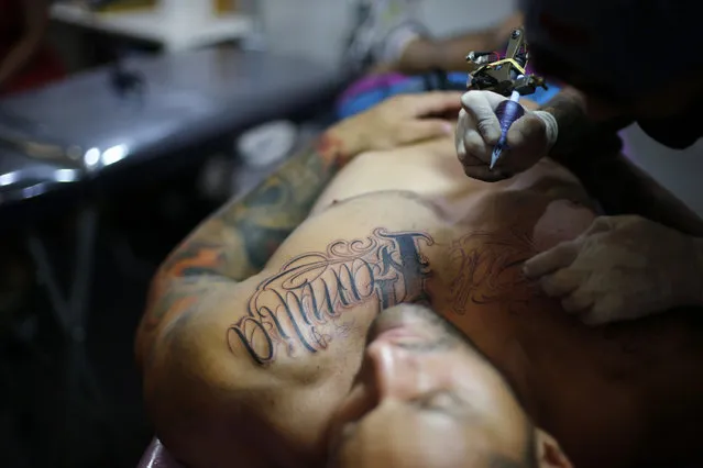 A man has the word “Family” tattooed on his chest during Rio Tattoo Week in Rio de Janeiro, Brazil, Friday, January 16, 2015. (Photo by Silvia Izquierdo/AP Photo)