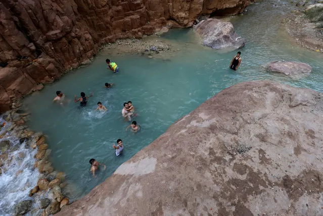 People swim in a river in the Valley of al-Zara, which flows into the Dead Sea, in Jordan, November 5, 2016. (Photo by Muhammad Hamed/Reuters)