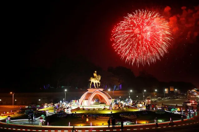 Fireworks released from Naypyitaw City Hall billow near statue of Gen. Aung San, late father of Myanmar leader Aung San Suu Kyi, to mark the 73rd Independence Day Monday, January 4, 2021, in Naypyitaw, Myanmar. (Photo by Aung Shine Oo/AP Photo)