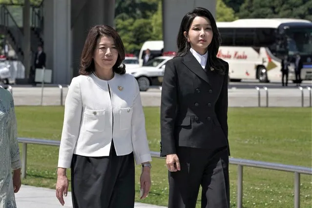 Kim Keon Hee (R), the wife of South Korea's Yoon Suk Yeol, walks with Japanese First Lady Yuko Kishida (L) as spouses of the leaders and representatives of the “Outreach” group at the G7 Summit Leaders' Meeting visit the Hiroshima Peace Memorial Park in Hiroshima on May 21, 2023. (Photo by Ministry of Foreign Affairs of Japan/Handout via AFP Photo)