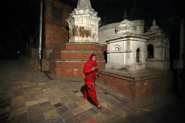 A devotee arrives to offer prayer during the Swasthani Brata Katha festival in Kathmandu January 20, 2015. (Photo by Navesh Chitrakar/Reuters)