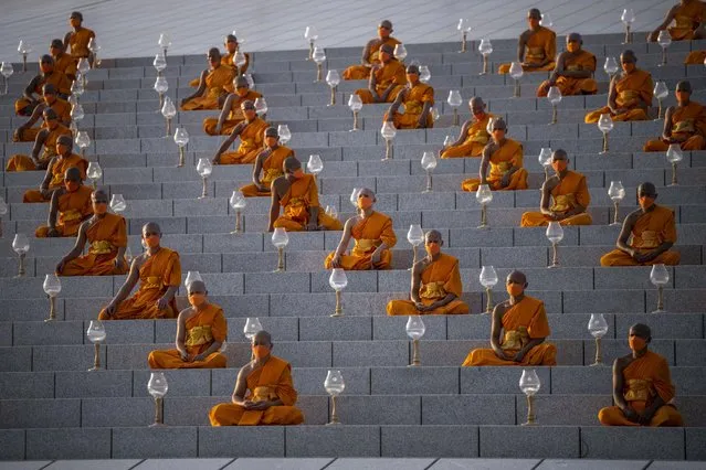 Buddhist monks take seats at the cetiya for the lantern lighting event and mass praying to honor the Buddha on the International Vesak Day at Wat Phra Dhammakaya Buddhist temple on the outskirt of Bangkok on June 03, 2023 in Pathum Thani, Thailand. Buddhists celebrated Vesak Day (also known as Visakha Bucha day in Thai), an auspicious day that commemorates the birth, enlightenment to Nirvana, and death of Gautama Buddha, whose teachings form the Buddhist religion. (Photo by Sirachai Arunrugstichai/Getty Images)