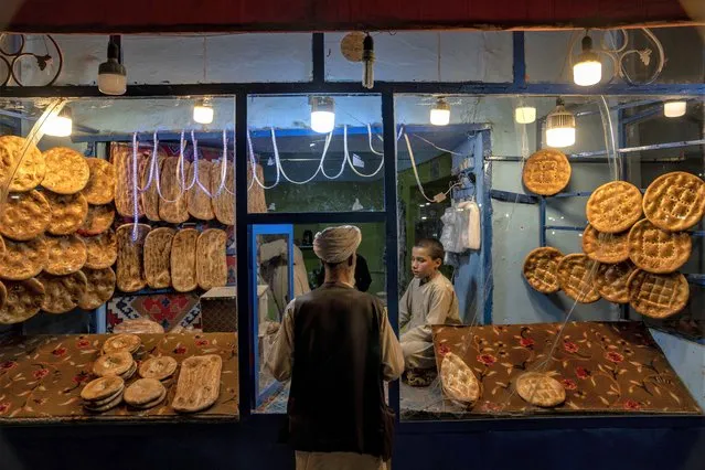 A man buys bread in downtown Herat, Afghanistan, Thursday, June 1, 2023. (Photo by Ebrahim Noroozi/AP Photo)