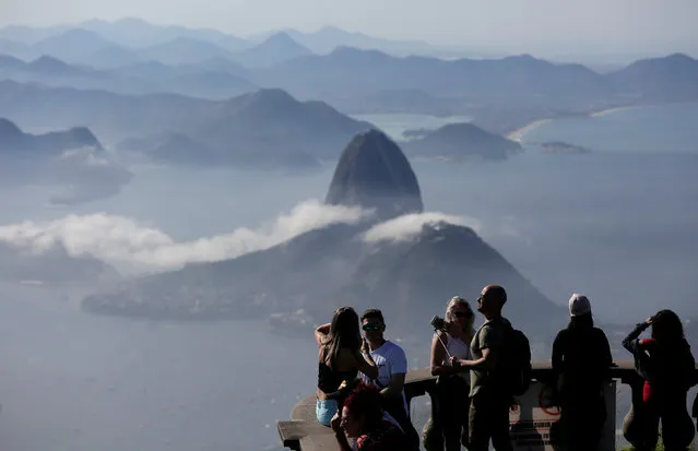 Tourists are seen with the Sugarloaf Mountain in the background in Rio de Janeiro, Brazil June 21, 2018. (Photo by Bruno Kelly/Reuters)