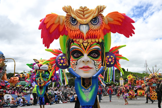 Artistas perform with traditional floats during the “Blacks and Whites” carnival parade in Pasto, Colombia, on January 6, 2025. The Blacks and Whites carnival has its origins in a mix of Andean, Amazonian and Pacific cultural expressions, and it celebrates the ethnic diversity in the region and was proclaimed by UNESCO as intangible cultural heritage in 2009. (Photo by Raul Arboleda/AFP Photo)