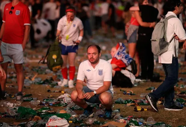 England soccer fans react after losing the semifinal match between Croatia and England at the 2018 soccer World Cup, in Hyde Park, London, Wednesday, July 11, 2018. (Photo by Matt Dunham/AP Photo)