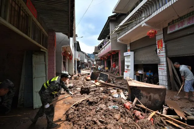 Local people clean up silt and garbage in Caotan Village of Yantouzhai Town, Hunan Province, China 02 July 2023. Torrential rain has been battering parts of Hunan since 29 June with the Xiangxi Tujia and Miao Autonomous Prefecture experiencing the most severe rainfall since the flood season, according to the Hunan provincial flood and drought control headquarters on 01 July. (Photo by Chen Zhenhai/EPA via Xinhua News Agency)