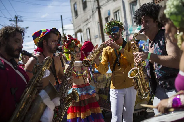 Revelers perform during the “Ceu na Terra”, or Heaven on earth, carnival parade in Rio de Janeiro, Brazil, Saturday, February 7, 2015. (Photo by Felipe Dana/AP Photo)