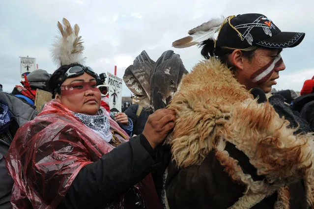 Protesters prepare to cross a river to Turtle Island on Thanksgiving day during a protest against plans to pass the Dakota Access pipeline near the Standing Rock Indian Reservation, near Cannon Ball, North Dakota, U.S. November 24, 2016. (Photo by Stephanie Keith/Reuters)