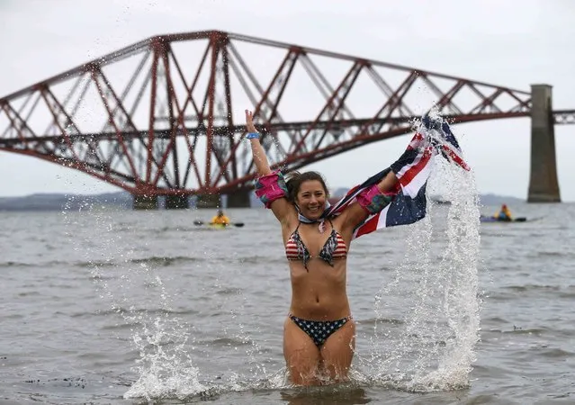 A swimmer participates in the New Year's Day Loony Dook swim at South Queensferry in Scotland, Britain January 1, 2016. (Photo by Russell Cheyne/Reuters)