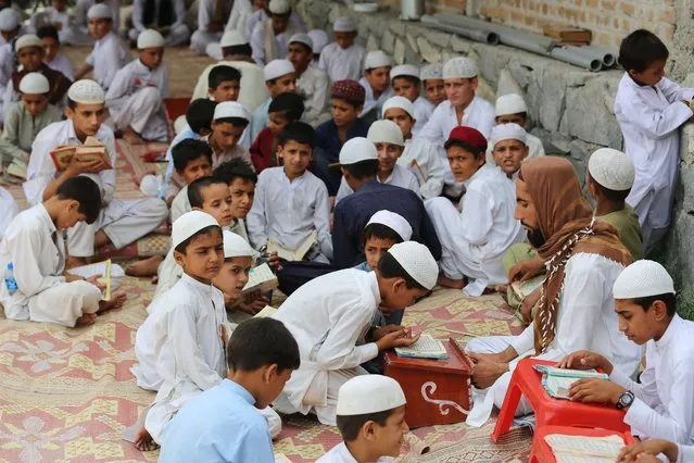 Afghan boys learn the holy Koran at a madrassa or an Islamic school in Kama District of Nangarhar province on July 19, 2023 (Photo by Shafiullah Kakar/AFP Photo)