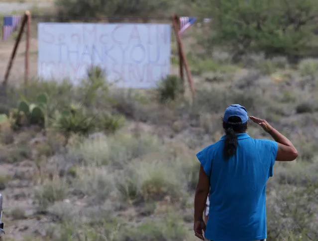 A military veteran pays his respects, as John McCain has discontinued medical treatment for an aggressive form of brain cancer, at the entrance to the McCain ranch complex in Cornville, Ariz., Saturday, August 25, 2018. Arizona Sen. McCain, the war hero who became the GOP's standard-bearer in the 2008 election, has died. He was 81. His office says McCain died Saturday, Aug. 25, 2018. He had battled brain cancer. (Photo by Ross D. Franklin/AP Photo)