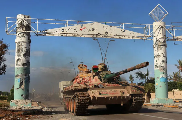 A tank is seen in the city of Sirte, Libya October 16, 2011. Libyan government fighters battled to subdue pockets of resistance by pro-Gaddafi fighters, whose refuse to abandon the ousted leader's hometown of Sirte. (Photo by Esam Al-Fetori/Reuters)