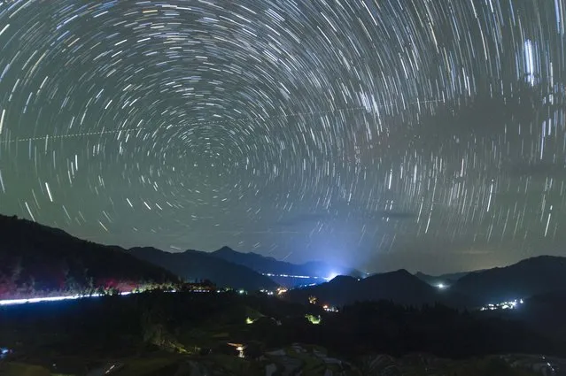 The starry sky is seen above the Kampung rice terraces in Congjiang County, Guizhou province, China on September 20, 2023. (Photo by Costfoto/NurPhoto/Rex Features/Shutterstock)