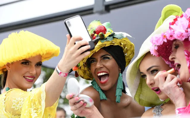 Spectators pose for a selfie before the running of the Melbourne Cup at the Flemington Racecourse in Melbourne, Australia, Tuesday, November 6, 2018. (Photo by Andy Brownbill/AP Photo)