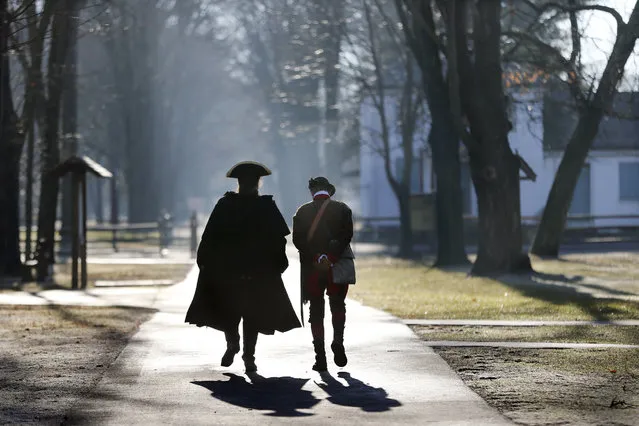 Revolutionary War re-enactors walk along a path before the re-enactment of Gen. George Washington's Christmas Day crossing to New Jersey on Sunday, December 25, 2016, in Washington Crossing, Pa. (Photo by Mel Evans/AP Photo)