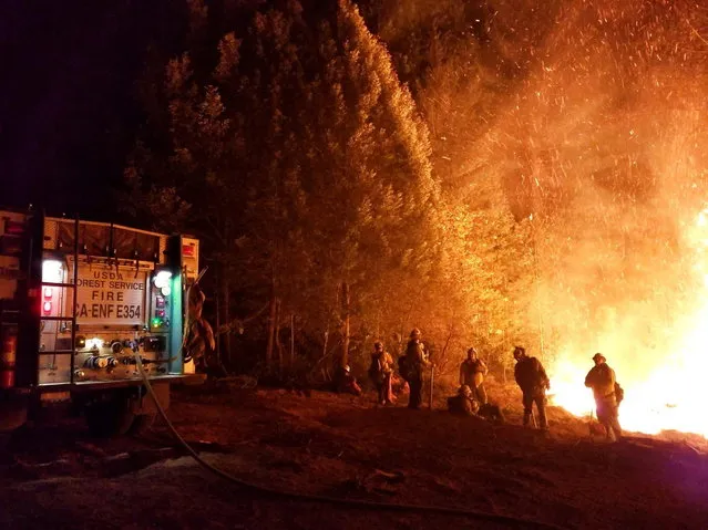 An undated handout photo made available by the United States Forest Service (USFS) and the National Wildfire Coordinating Group (NWCG) on Inciweb on 20 November 2018 shows firefighters battling the Camp Fire in Northern California, USA. The death toll from the Camp Fire increased to 79 on 19 November 2018, as the blaze destroyed thousands of homes. Officials said that around 1,000 people are missing and unaccounted for. The fire, the deadliest and most destructive wildfire in the state's history, has scorched as of 20 November 2018, some 151,000 acres and has been 70 percent contained. (Photo by EPA/USFS/NWCG)