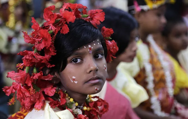 A young Hindu girl sits for a ceremony where she and other girls are worshipped as “Kumari”, or living goddess, during Ram Navami festival, at a temple in Kolkata, India, Saturday, March 28, 2015. (Photo by Bikas Das/AP Photo)