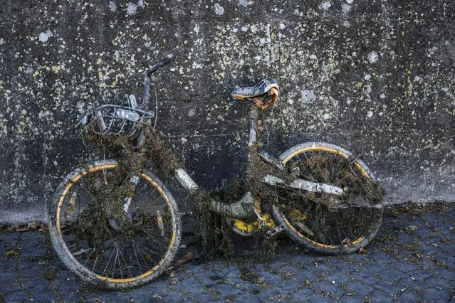 A bicycle emerged from the river bed sits on the banks of the Tiber river, in Rome, Monday, August 22, 2022. Italy's worst drought in 70 years has exposed the piers of an ancient bridge over the Tiber River once used by Roman emperors but which fell into disrepair by the 3rd Century. (Photo by Gregorio Borgia/AP Photo)
