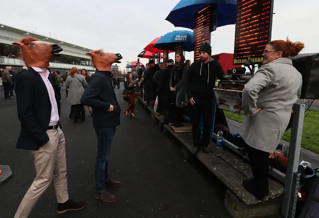 Racegoers in fancy dress look at bookmakers’ odds boards during day two of the Leopardstown Christmas festival in Leopardstown, Ireland on December 27, 2018. (Photo by Brian Lawless/PA Wire Press Association)