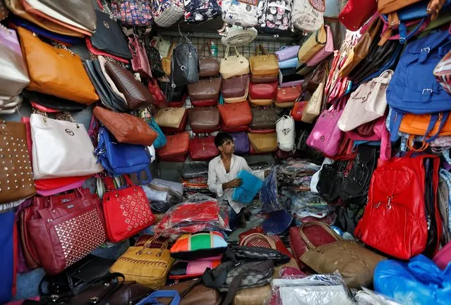 A vendor arranges bags as he waits for customers at his shop at a market in Mumbai, India, January 6, 2017. (Photo by Danish Siddiqui/Reuters)