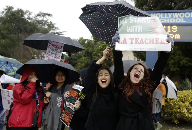 Maria Arienza, right, an English and Spanish teacher, shouts slogans alongside her student Stephanie Medrano, second from right, outside of North Hollywood High School Tuesday, January 15, 2019, in Los Angeles. Teachers in the huge Los Angeles Unified School District walked picket lines again Tuesday as administrators urged them to return to classrooms and for their union to return to the bargaining table. (Photo by Marcio Jose Sanchez/AP Photo)