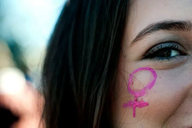 Angelina Nicastro of Denver, Colorado wears a painted Venus symbol during the Women's March in Denver, Colorado on January 19, 2019. Thousands of women gathered across the United States for their annual message opposing Donald Trump and supporting women's rights. (Photo by Jason Connolly/AFP Photo)